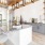 a room with a large table and grey cabinets