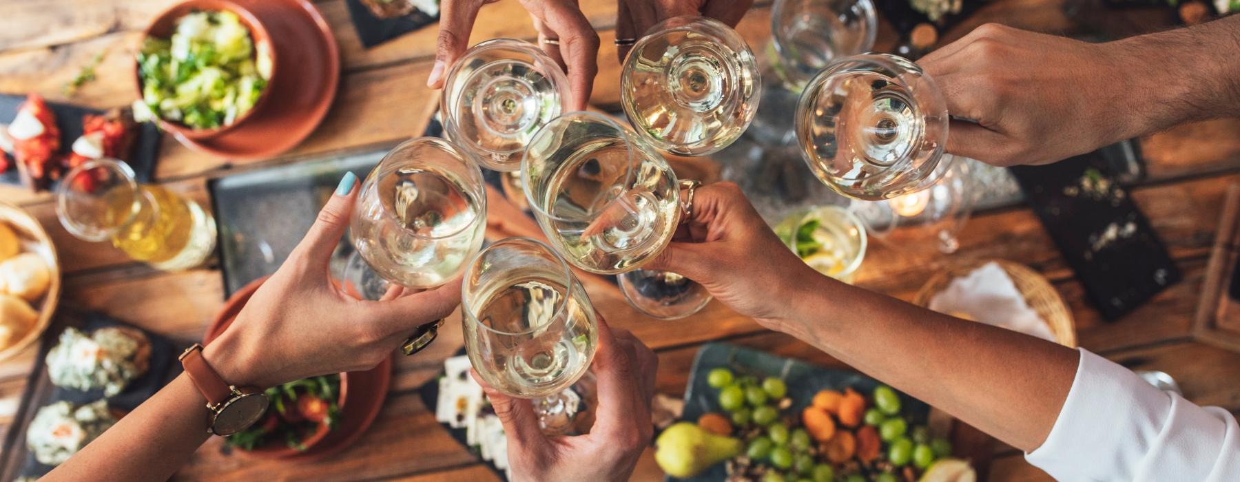 a group of people holding wine glasses