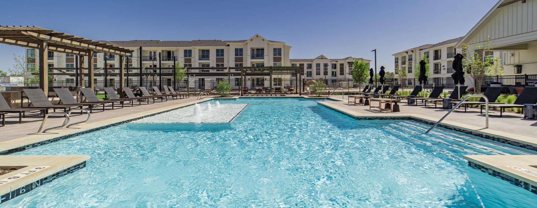 a swimming pool with a building in the background