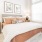 a bedroom with a bed and lamps