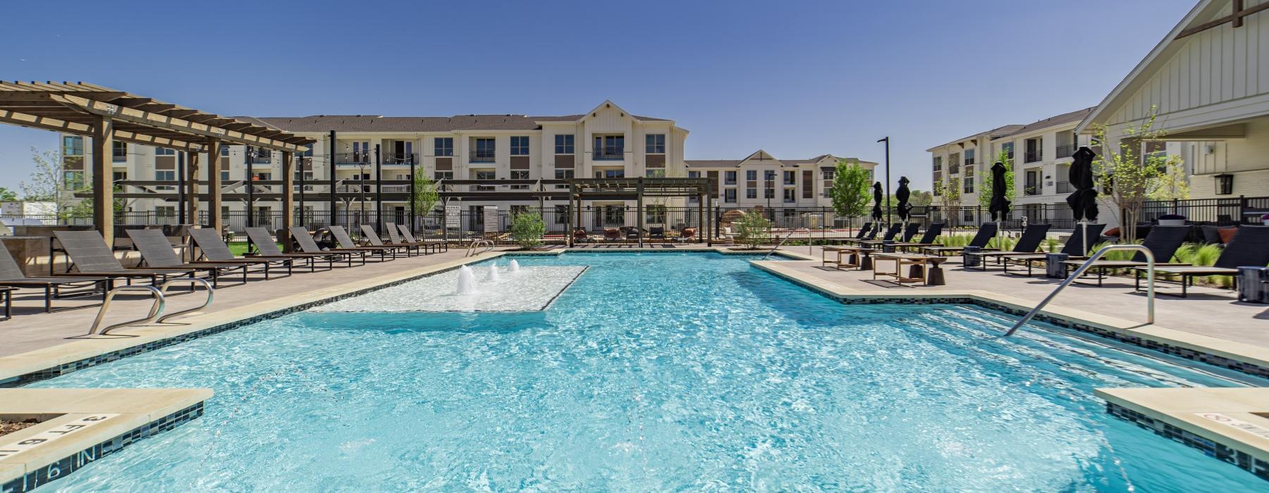 a swimming pool with a building in the background