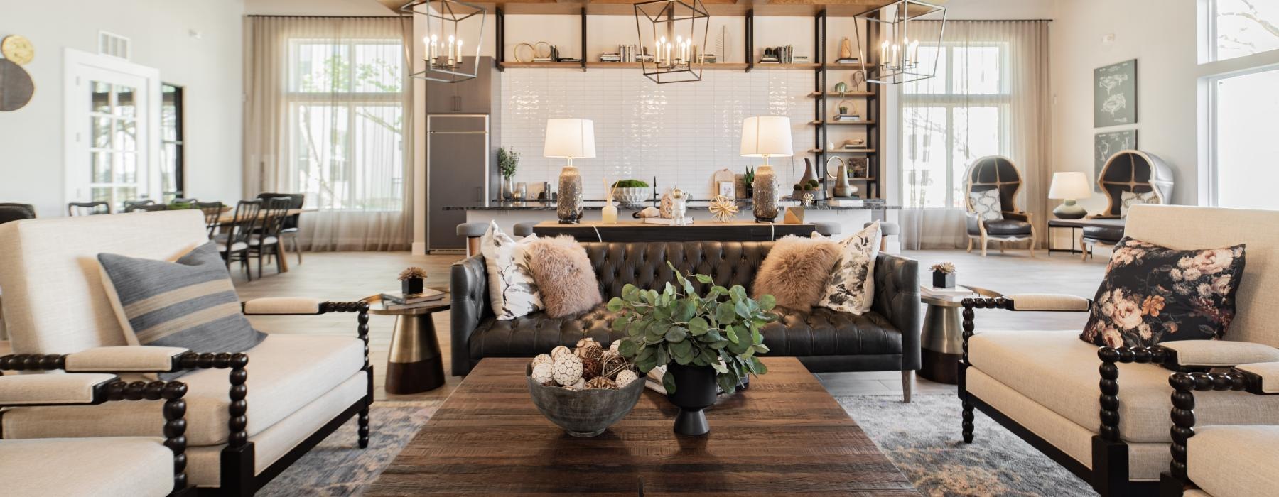 a living room with a large chandelier and a large table